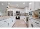 Bright, modern kitchen with white cabinets, stainless steel appliances, and granite countertops at 7257 Maguire Ln, Englewood, FL 34224