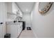Updated laundry room features granite countertops and black stainless steel appliances at 7257 Maguire Ln, Englewood, FL 34224