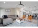 Inviting living room with comfortable seating, stylish decor, and seamless transition to the kitchen at 7257 Maguire Ln, Englewood, FL 34224