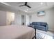 Spacious main bedroom featuring ensuite bathroom, walk-in closet, TV, and comfortable seating area at 7257 Maguire Ln, Englewood, FL 34224