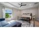 Serene main bedroom with tray ceiling, comfortable furnishings, and plenty of natural light at 7257 Maguire Ln, Englewood, FL 34224