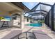 Screened in pool with lounge chairs and outdoor TV, perfect for relaxing and entertaining guests at 7257 Maguire Ln, Englewood, FL 34224