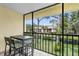 Relaxing screened balcony with a dining set overlooking a peaceful pond and green landscape at 756 White Pine Tree Rd # 204, Venice, FL 34285