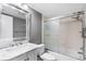 Modern bathroom features a vanity with marble countertop, sliding glass shower doors, and neutral color scheme at 756 White Pine Tree Rd # 204, Venice, FL 34285