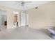 Light-filled bedroom showcases a closet, ensuite bathroom, ceiling fan, and neutral walls, creating a welcoming space at 756 White Pine Tree Rd # 204, Venice, FL 34285