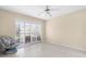 Bright bedroom features a ceiling fan, sliding glass doors, and light colored floors, offering an airy atmosphere at 756 White Pine Tree Rd # 204, Venice, FL 34285