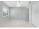 Light filled bedroom with a ceiling fan, bright window, closet, and white tile floors creates a calming atmosphere at 756 White Pine Tree Rd # 204, Venice, FL 34285