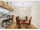 Bright dining area features a glass table, cushioned chairs, and a decorative chandelier, adjacent to the kitchen at 756 White Pine Tree Rd # 204, Venice, FL 34285