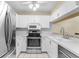White kitchen featuring modern appliances, and updated sink at 756 White Pine Tree Rd # 204, Venice, FL 34285