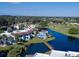 Aerial view of the community featuring a swimming pool and lush landscaping near a body of water at 800 Capri Isles Blvd # 235, Venice, FL 34292
