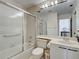 This is a bathroom featuring a shower-tub combo with sliding door, sink, and toilet at 800 Capri Isles Blvd # 235, Venice, FL 34292