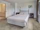 Bedroom featuring a tan carpet, a gold frame bed and an ensuite bathroom at 800 Capri Isles Blvd # 235, Venice, FL 34292