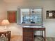 Bright bedroom featuring a woven desk, neutral walls, and view of the outdoors at 800 Capri Isles Blvd # 235, Venice, FL 34292