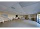 Bright community room with ample seating, tables, and a mounted TV, perfect for gatherings and events at 800 Capri Isles Blvd # 235, Venice, FL 34292