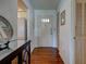 Entryway with wood flooring and closet to the right of the front door and kitchen access on the left at 800 Capri Isles Blvd # 235, Venice, FL 34292