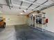 Spacious two car garage, with overhead storage, shelving, and storage bins along the walls at 800 Capri Isles Blvd # 235, Venice, FL 34292
