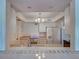 Bright kitchen with white appliances, cabinets, and ample counter space at 800 Capri Isles Blvd # 235, Venice, FL 34292
