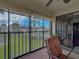 Cozy lanai with comfortable chairs offering views of pool and community landscape at 800 Capri Isles Blvd # 235, Venice, FL 34292