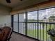 Screened-in lanai overlooking a pond with a fountain in a quiet neighborhood at 800 Capri Isles Blvd # 235, Venice, FL 34292