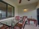 Relaxing lanai with comfortable seating and textured walls overlooking outside at 800 Capri Isles Blvd # 235, Venice, FL 34292
