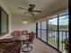 Relaxing lanai with comfortable seating and ceiling fan overlooking the community at 800 Capri Isles Blvd # 235, Venice, FL 34292