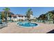 Inviting community pool with ample seating, lounge chairs, and umbrellas, perfect for relaxation and socializing at 800 Capri Isles Blvd # 235, Venice, FL 34292