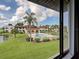View from window of the community pool and surrounding manicured lawn at 800 Capri Isles Blvd # 235, Venice, FL 34292