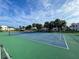 Outdoor community tennis court featuring green and blue playing surface with a clear blue sky at 800 Capri Isles Blvd # 235, Venice, FL 34292
