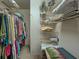 Walk-in closet featuring wire shelving and a variety of clothing at 800 Capri Isles Blvd # 235, Venice, FL 34292