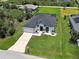 Aerial view of home featuring landscaping, long driveway, and attached two-car garage at 9157 Genesee St, Port Charlotte, FL 33981