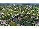 Wide aerial view of neighborhood with view of water and nearby homes and greenery at 9157 Genesee St, Port Charlotte, FL 33981
