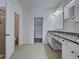 Bright bathroom featuring a shower, separate toilet, and granite countertop vanity at 9157 Genesee St, Port Charlotte, FL 33981
