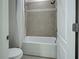 This bathroom has a shower-tub combo, tile surround and a white shower curtain at 9157 Genesee St, Port Charlotte, FL 33981
