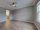 Spacious bedroom with wood flooring, crown molding, a ceiling fan, and a view into the bathroom at 9157 Genesee St, Port Charlotte, FL 33981