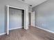 Bedroom featuring wood-look flooring, closet with folding doors, and neutral paint at 9157 Genesee St, Port Charlotte, FL 33981