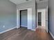 This bedroom has wood floors, neutral paint, closet with folding doors and an entry door to the hall at 9157 Genesee St, Port Charlotte, FL 33981
