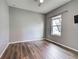 Bedroom with wood floors, a ceiling fan, and a large window at 9157 Genesee St, Port Charlotte, FL 33981
