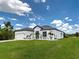 Charming single-story home featuring a well-manicured lawn and white rock landscaping for added curb appeal at 9157 Genesee St, Port Charlotte, FL 33981