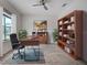 Bright home office featuring a large desk, shelves and a window with natural light at 9157 Genesee St, Port Charlotte, FL 33981