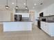 Modern kitchen with white cabinetry, granite countertops, stainless steel appliances, and a breakfast bar at 9157 Genesee St, Port Charlotte, FL 33981