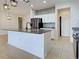 Spacious kitchen features a large island with granite countertop, stainless steel appliances, and white cabinets at 9157 Genesee St, Port Charlotte, FL 33981