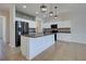 Modern kitchen boasts stainless steel appliances, granite countertops, a central island, and stylish pendant lighting at 9157 Genesee St, Port Charlotte, FL 33981