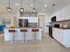Well-lit kitchen featuring white cabinets, granite countertops, stainless appliances, and stylish bar seating at 9157 Genesee St, Port Charlotte, FL 33981