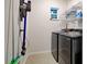 Laundry room with modern appliances, shelving, and a window, providing a functional and organized space at 9157 Genesee St, Port Charlotte, FL 33981