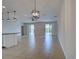 Spacious living area featuring tile flooring, modern light fixtures, and access to outdoor spaces at 9157 Genesee St, Port Charlotte, FL 33981