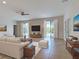 Comfortable living room with neutral tones, tile flooring, and sliding glass doors leading to the outdoors at 9157 Genesee St, Port Charlotte, FL 33981