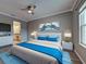 Serene main bedroom with wood floors, a ceiling fan, ensuite bathroom and a bright window at 9157 Genesee St, Port Charlotte, FL 33981