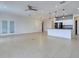 Bright, open floorplan featuring tile flooring, modern lighting, and a seamless transition to the kitchen at 9157 Genesee St, Port Charlotte, FL 33981