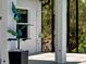 This covered lanai features an outdoor shower and view of the trees and other lush landscaping at 9157 Genesee St, Port Charlotte, FL 33981