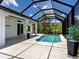 Screened-in lanai features a pool, tile flooring, ceiling fan and ample space for seating and entertaining at 9157 Genesee St, Port Charlotte, FL 33981